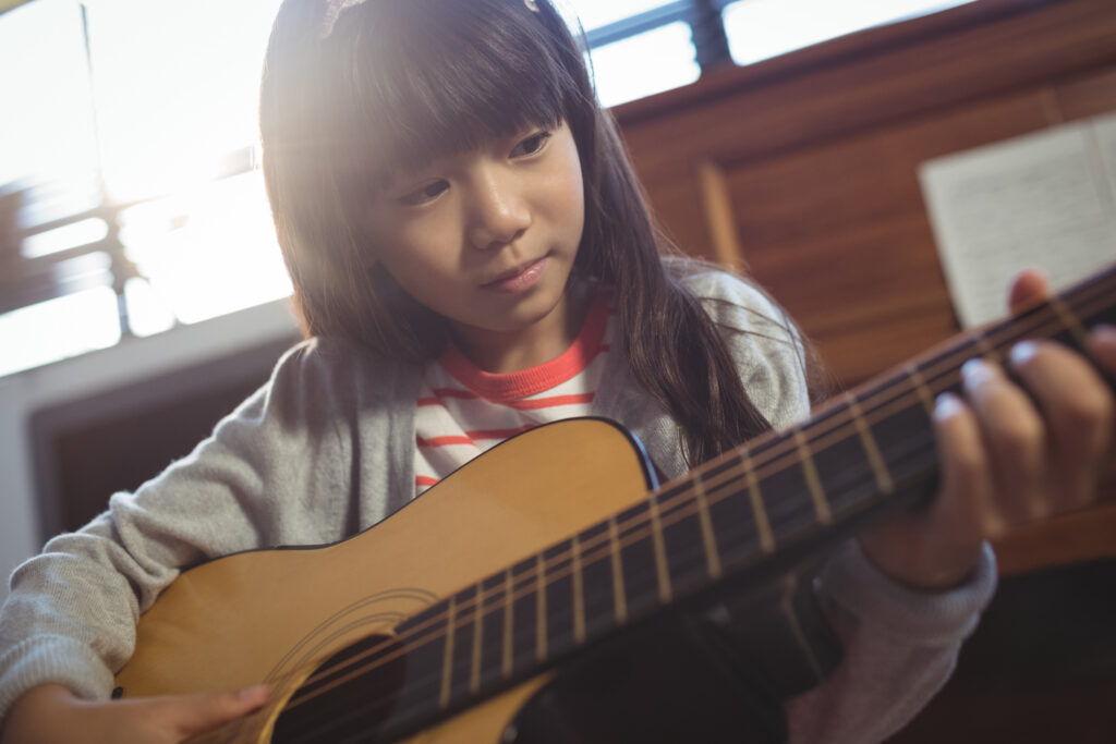 Student practicing her guitar